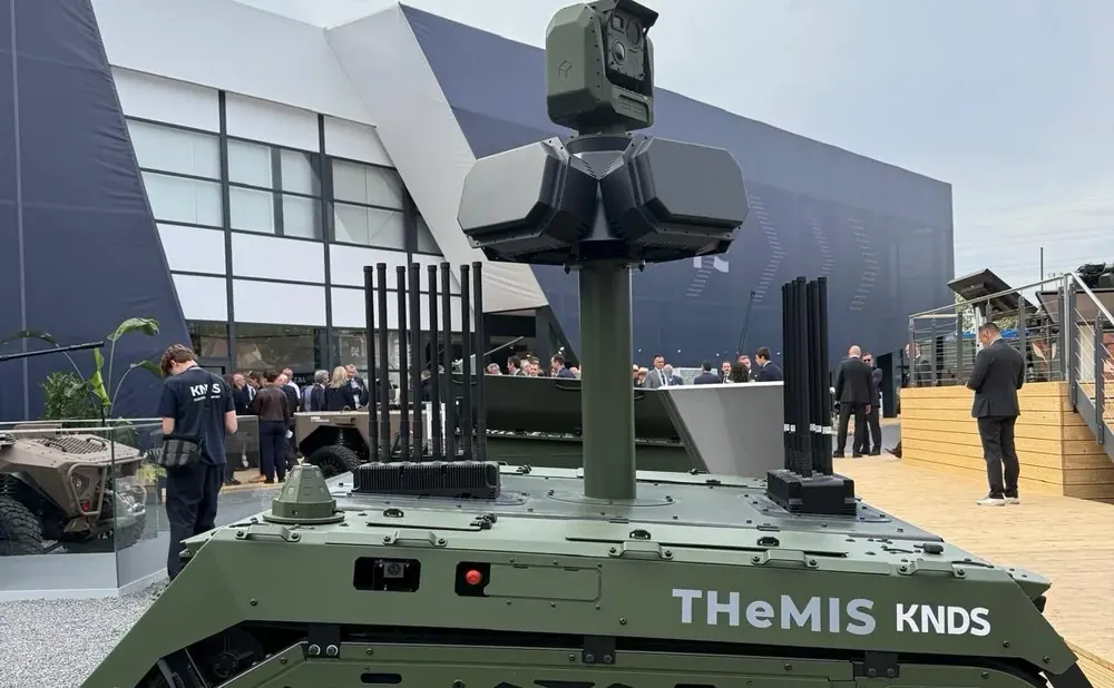 Tracked unmanned ground vehicle fitted with London Defence R&D RF effector antennas, on display at a defence exhibition